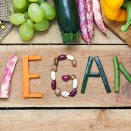 vegan word on wood background and vegetable