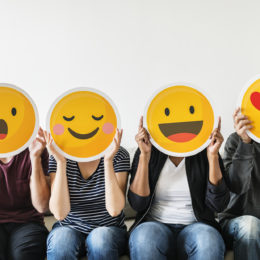People holding emoticons